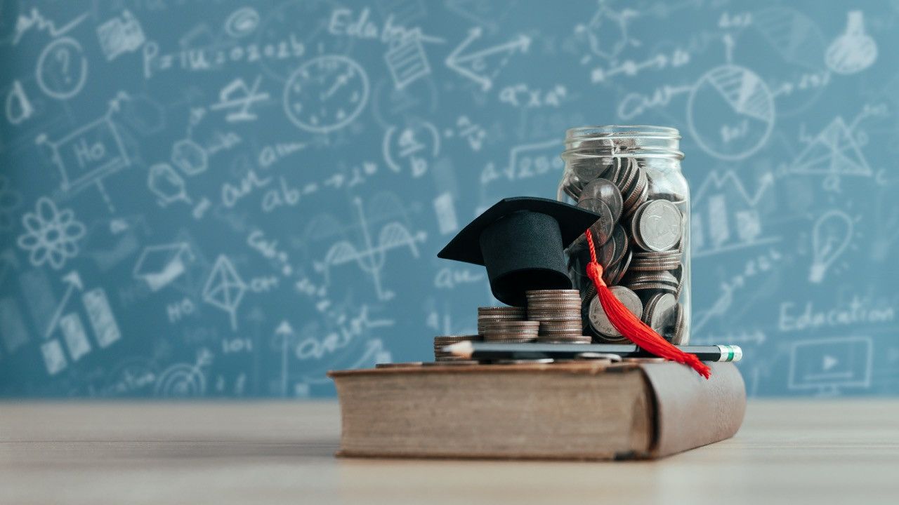 Conceptual image for education funding - stack of coins on a book.