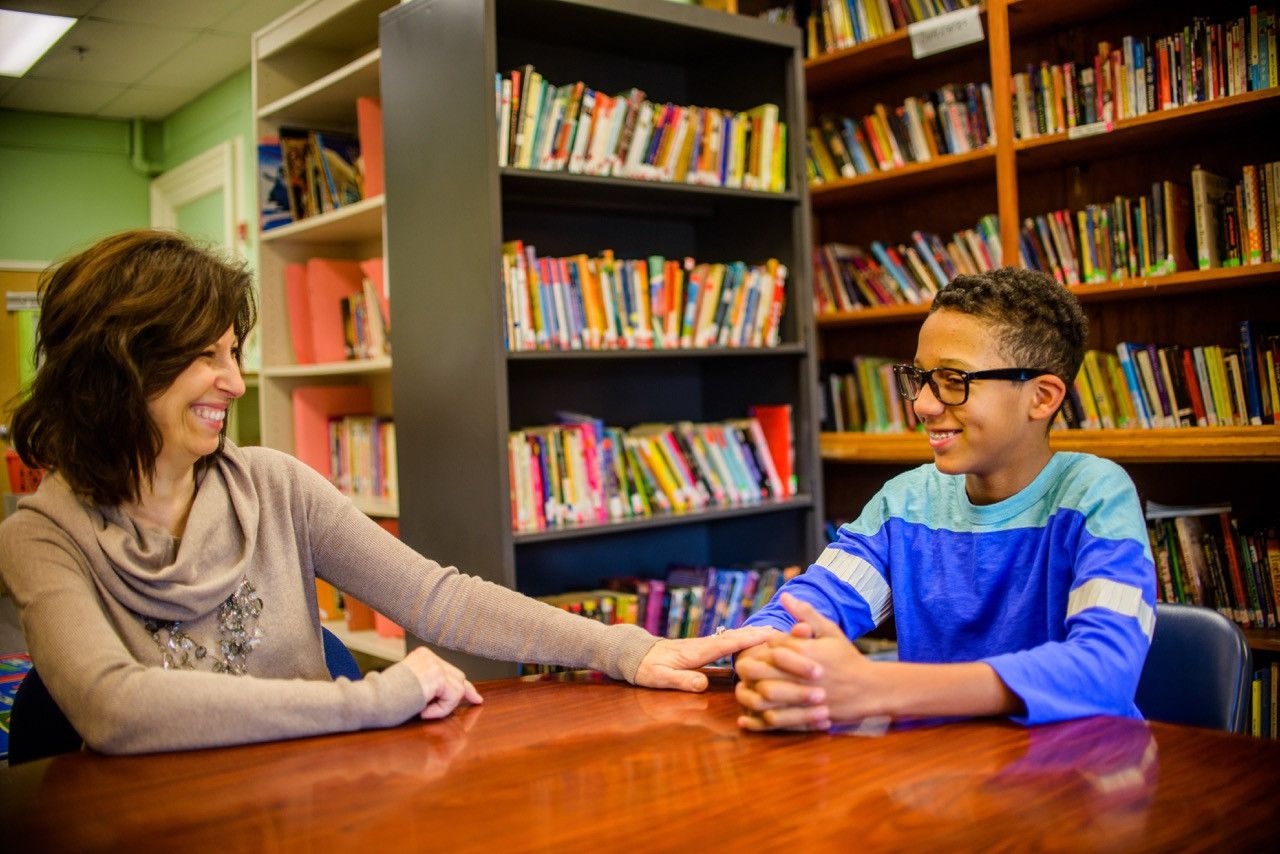 Student speaking with school counselor.